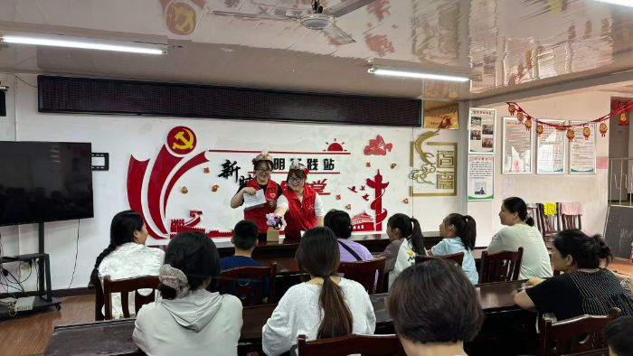 图为实践队员开展民族团结趣味问答,和现场居民互动交流
